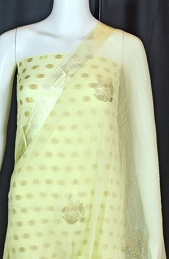 Sheer cream chiffon saree with gold dot motifs and thin embellished border