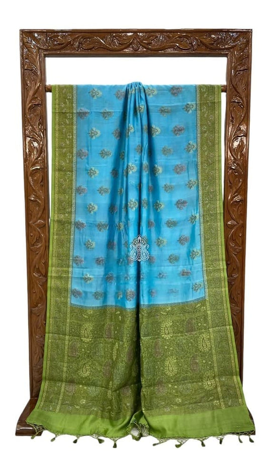Banarasi saree laid flat, turquoise with gold motifs, green border and gathered pallu