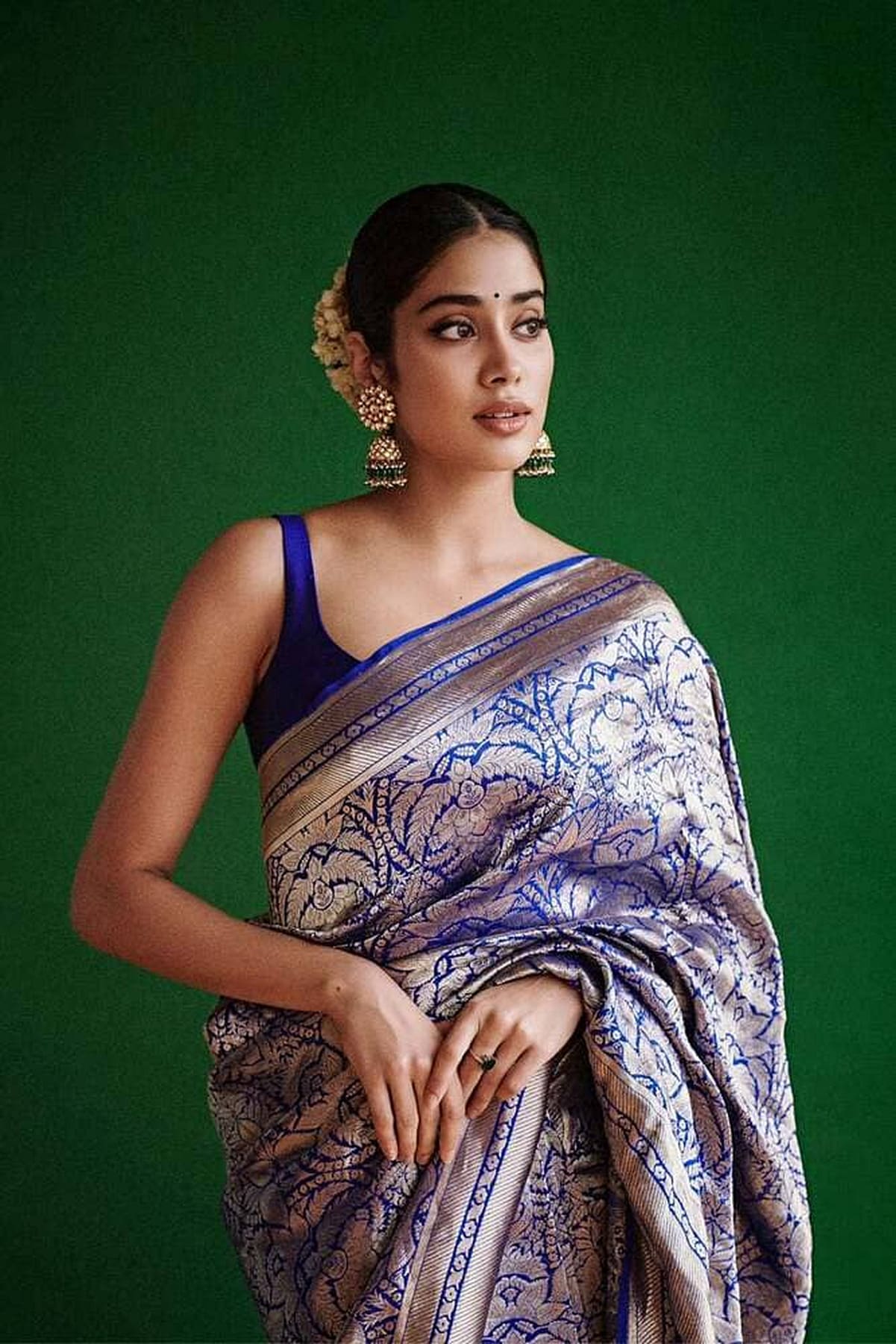 Silk saree with blue border and purple floral brocade, pallu folded at waist
