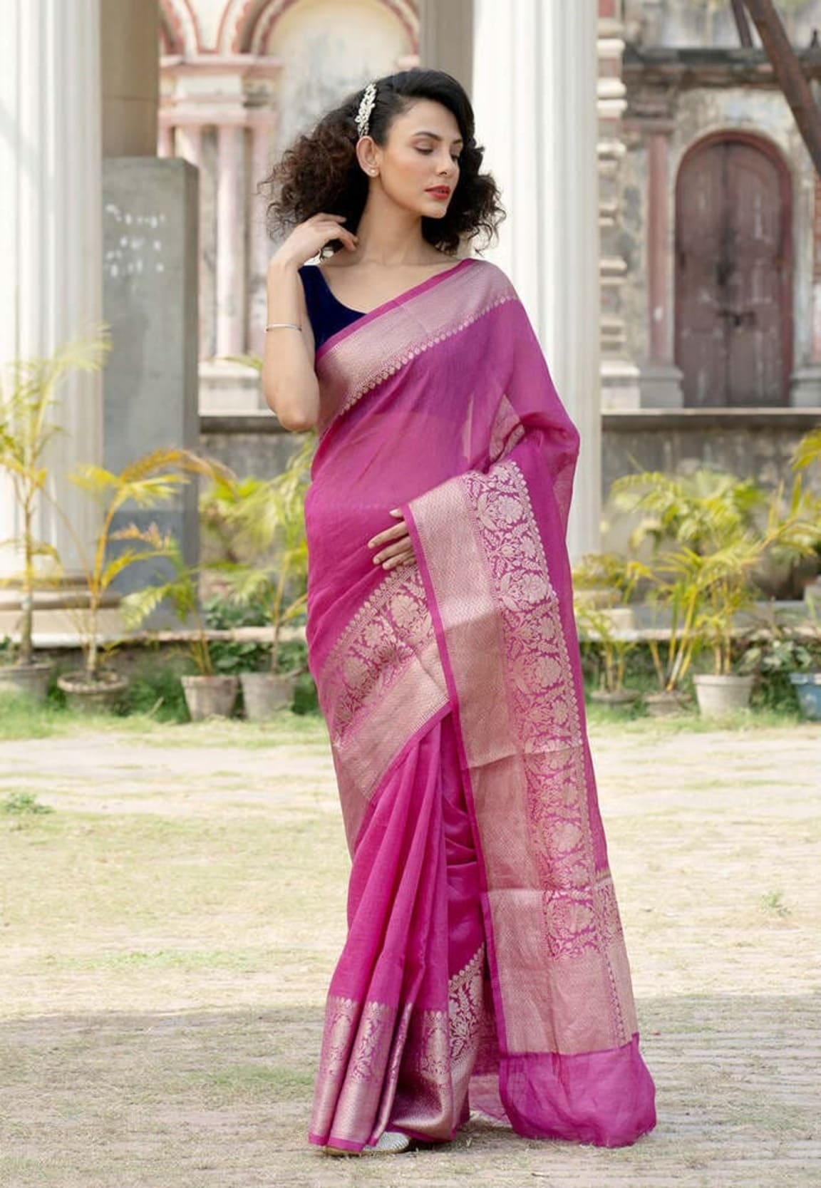 Magenta linen Banarasi saree with decorative pallu and zari-trimmed border