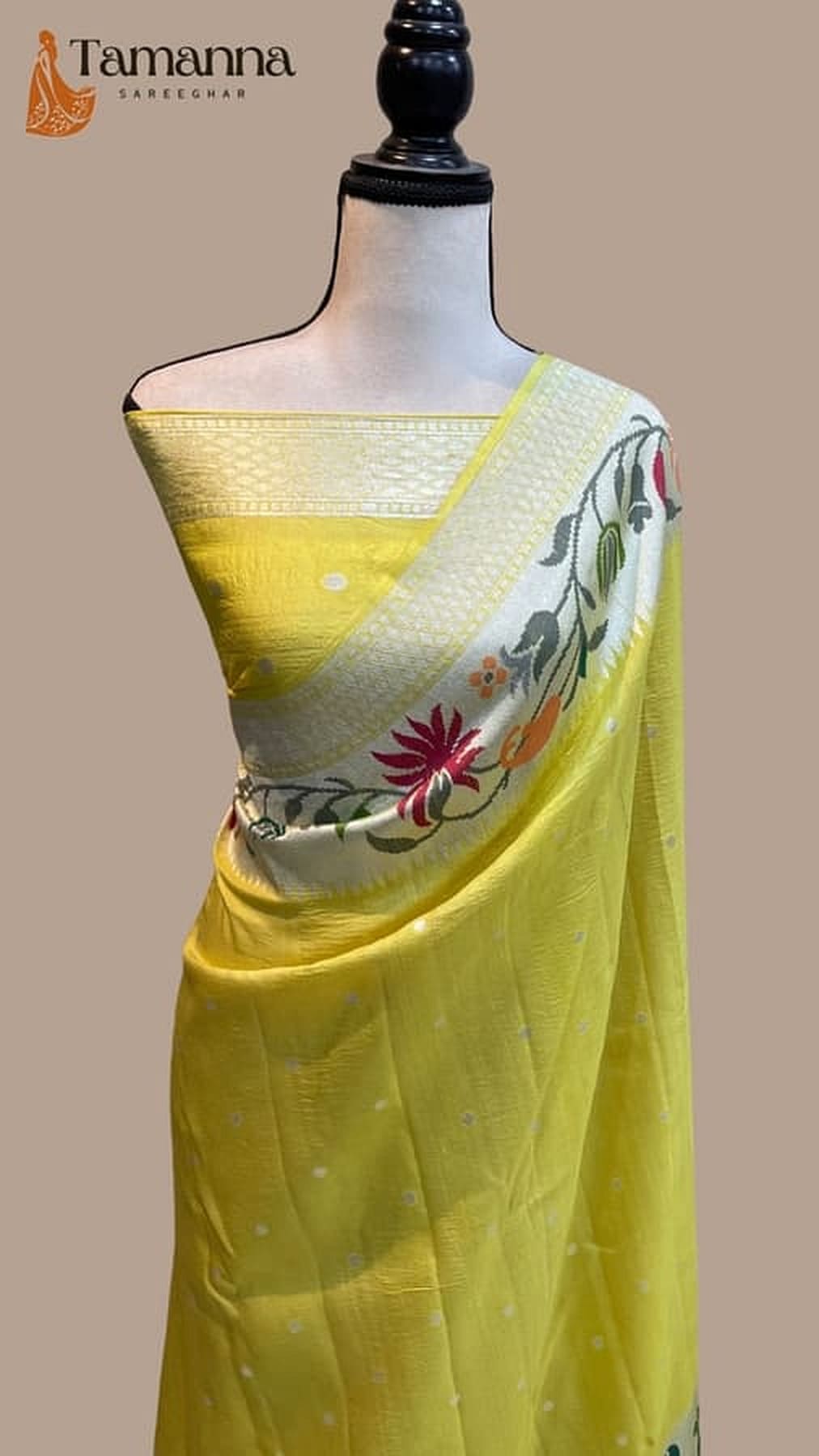 Mango-yellow saree with solid body, speckled texture, and floral Paithani border