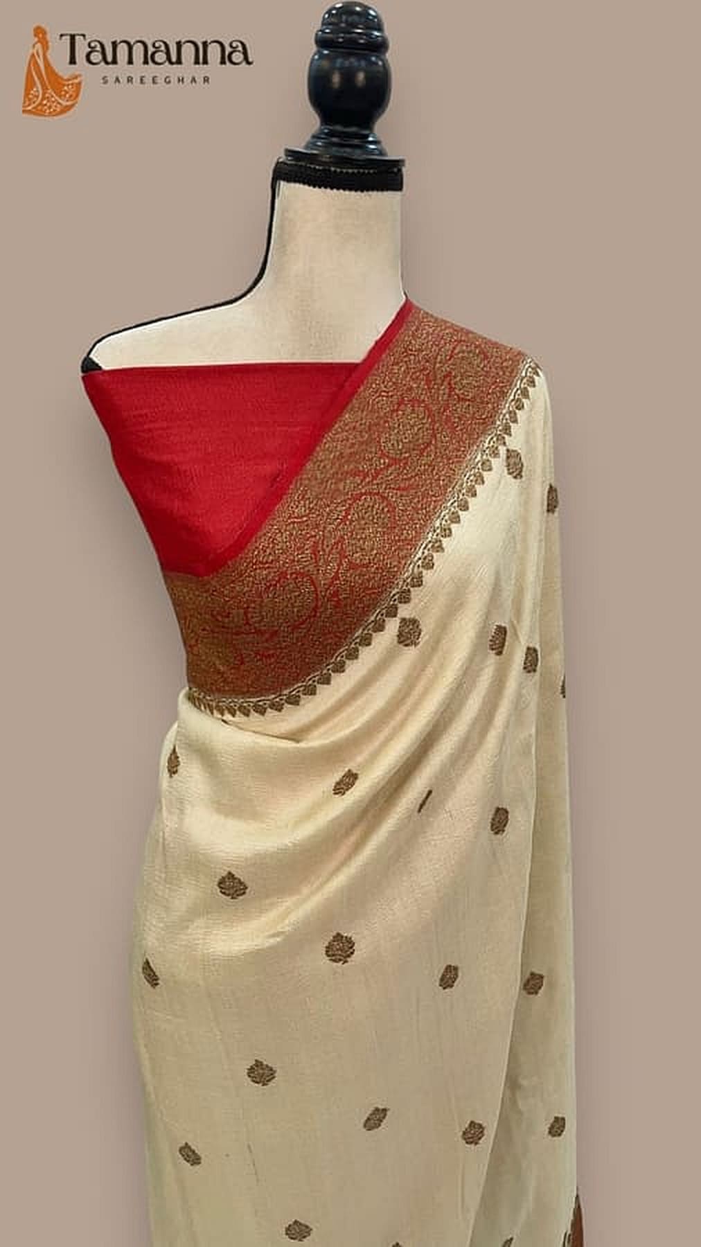 Off-white silk saree with bronze-gold border, red pallu, and scattered motif dots