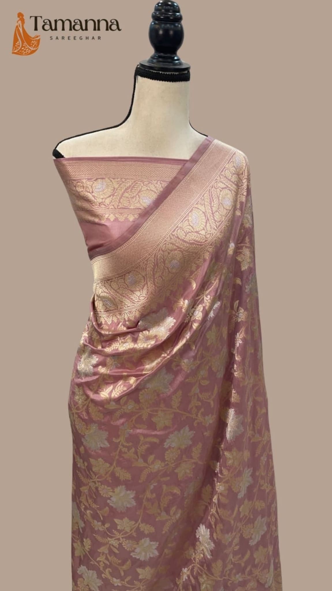 Pink silk saree with gold-toned woven motifs, neatly draped over mannequin