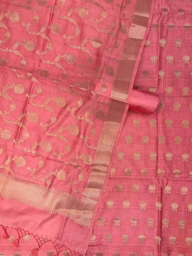 Close-up pink silk dress fabric with gold zari pattern and border stripes