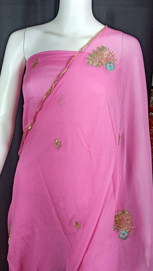 Light pink chiffon saree with sheer pallu, gold border, and scattered floral embellishments