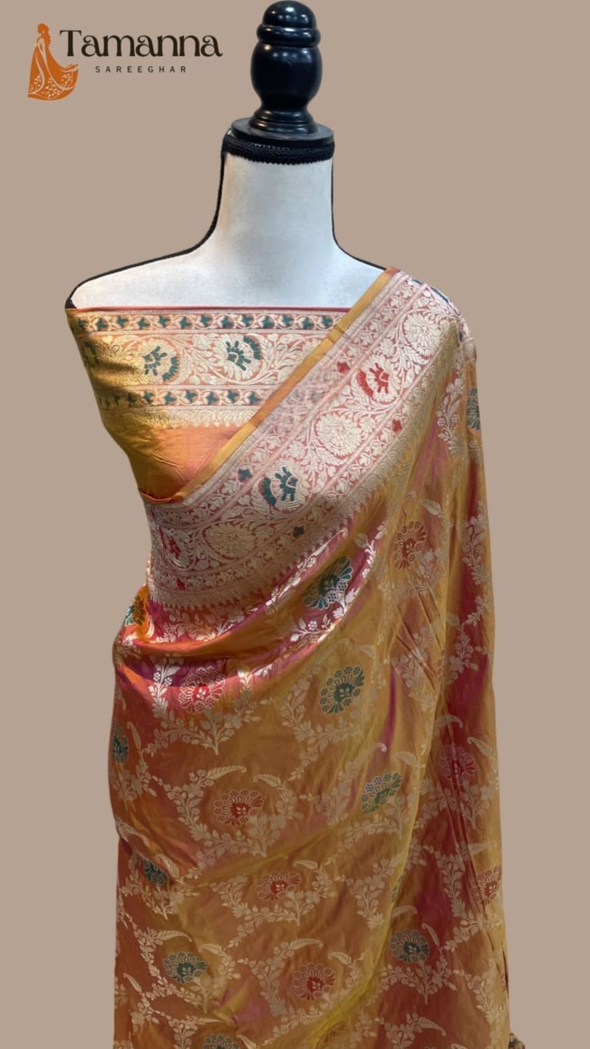 Banarasi silk saree on mannequin, golden-beige pallu with maroon highlights and ornate weave
