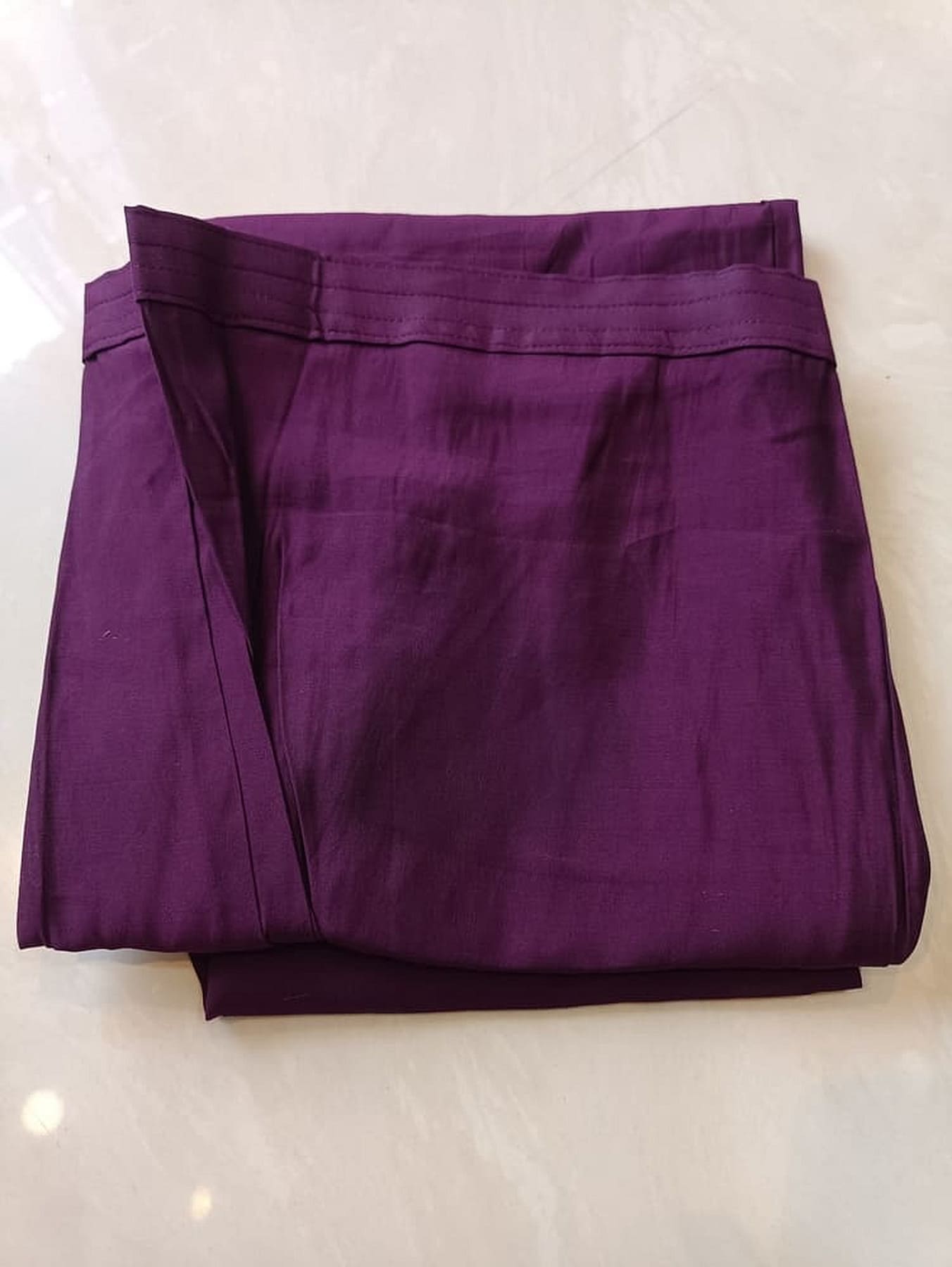 Purple pure silk trousers, folded with stitched hem and pleated front