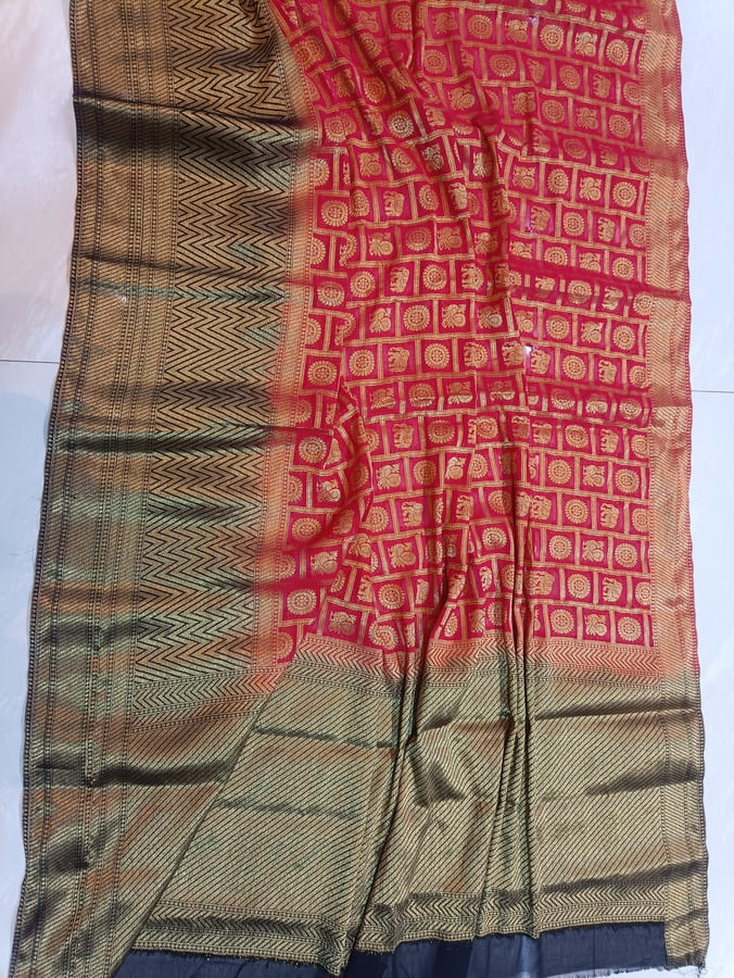 Red chiffon saree close-up of gold zari motif pattern and contrasting woven end