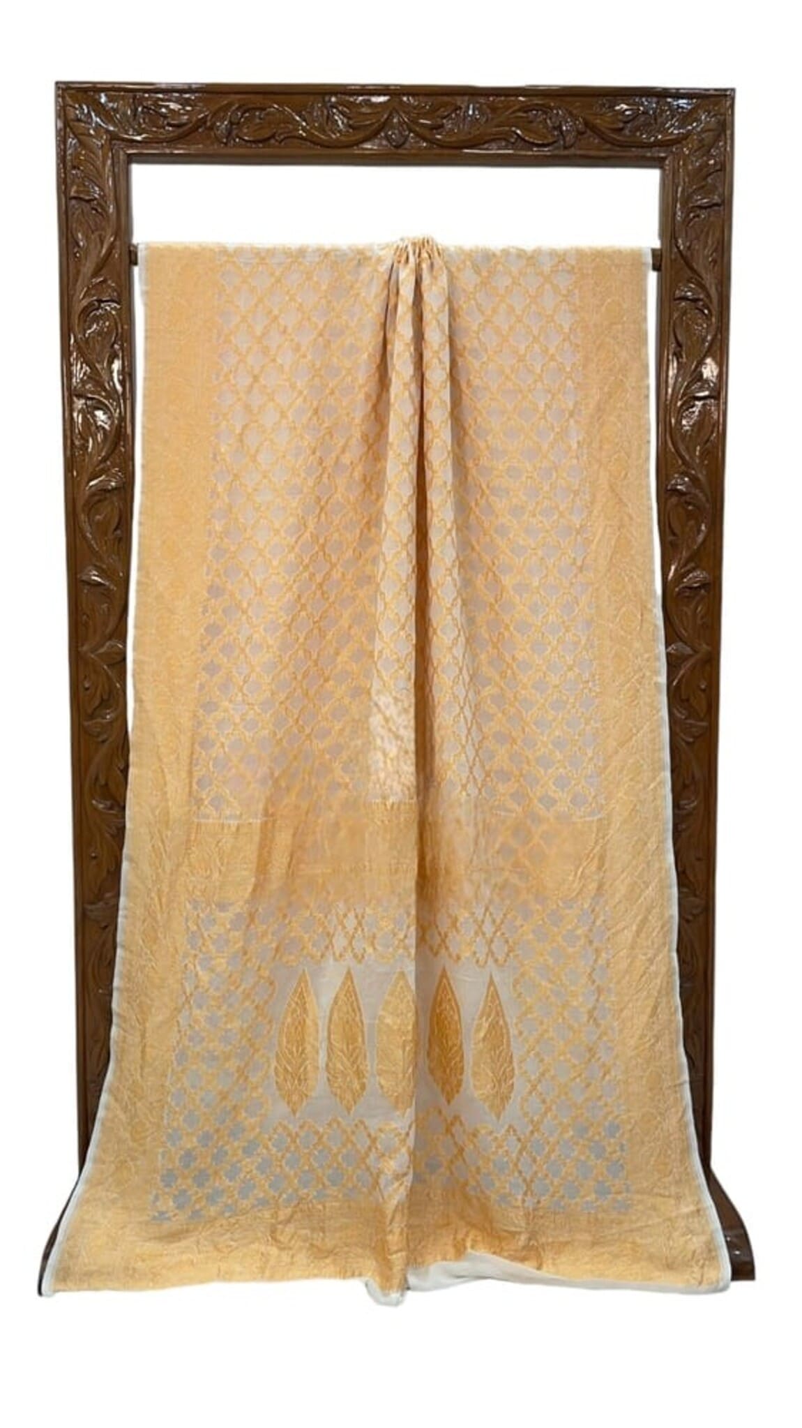 Cream saree full view with gold allover jaal and stylized motif border along hem