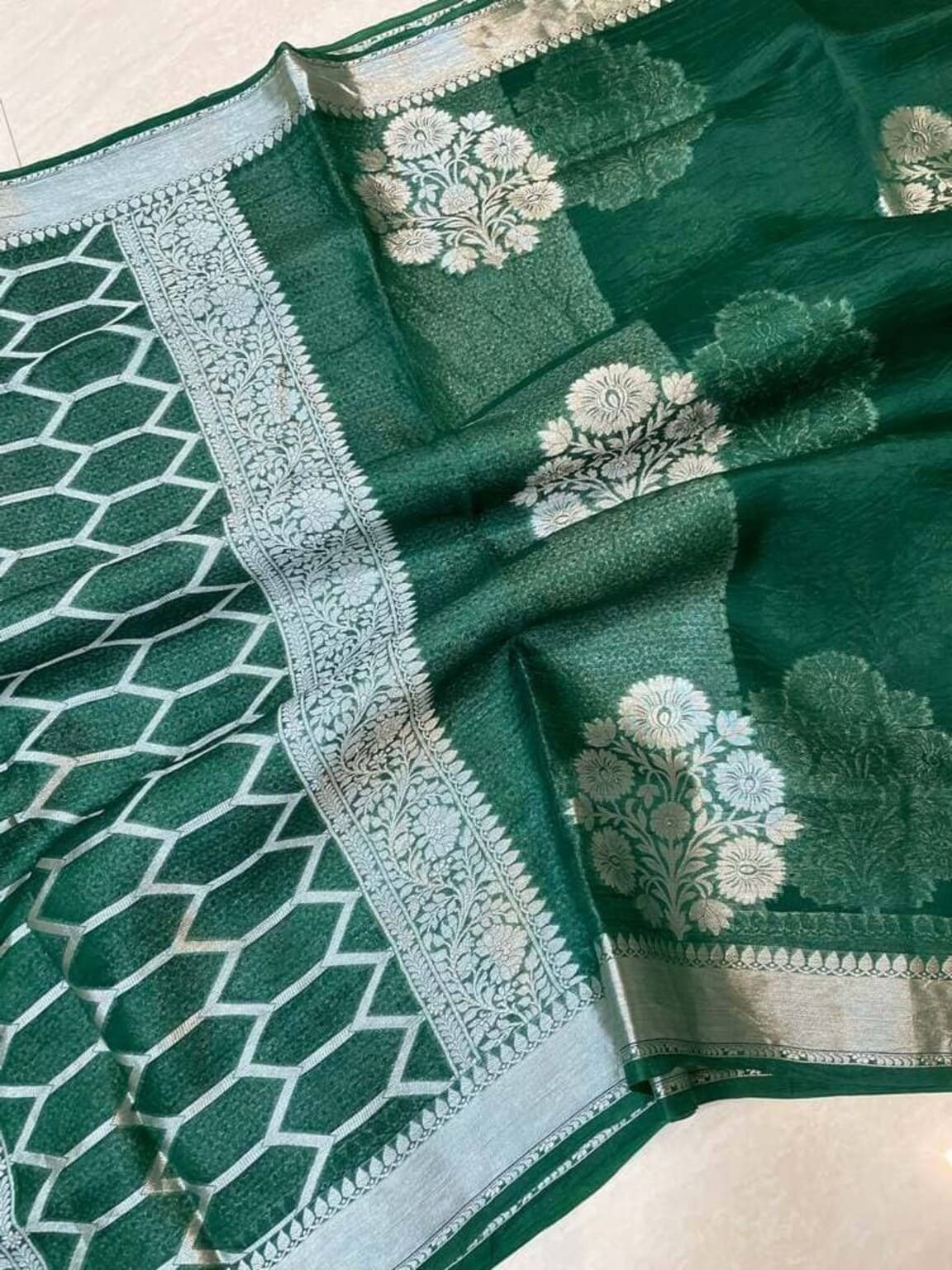 Dark green Banarasi saree pallu with silver woven border and geometric pattern