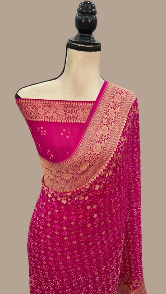 Magenta saree with gold pallu border and all-over dotted pattern on mannequin