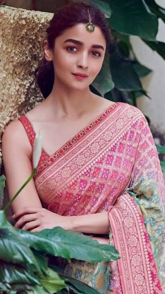 Pink banarasi saree with ornate zari border and geometric motifs on shoulder drape