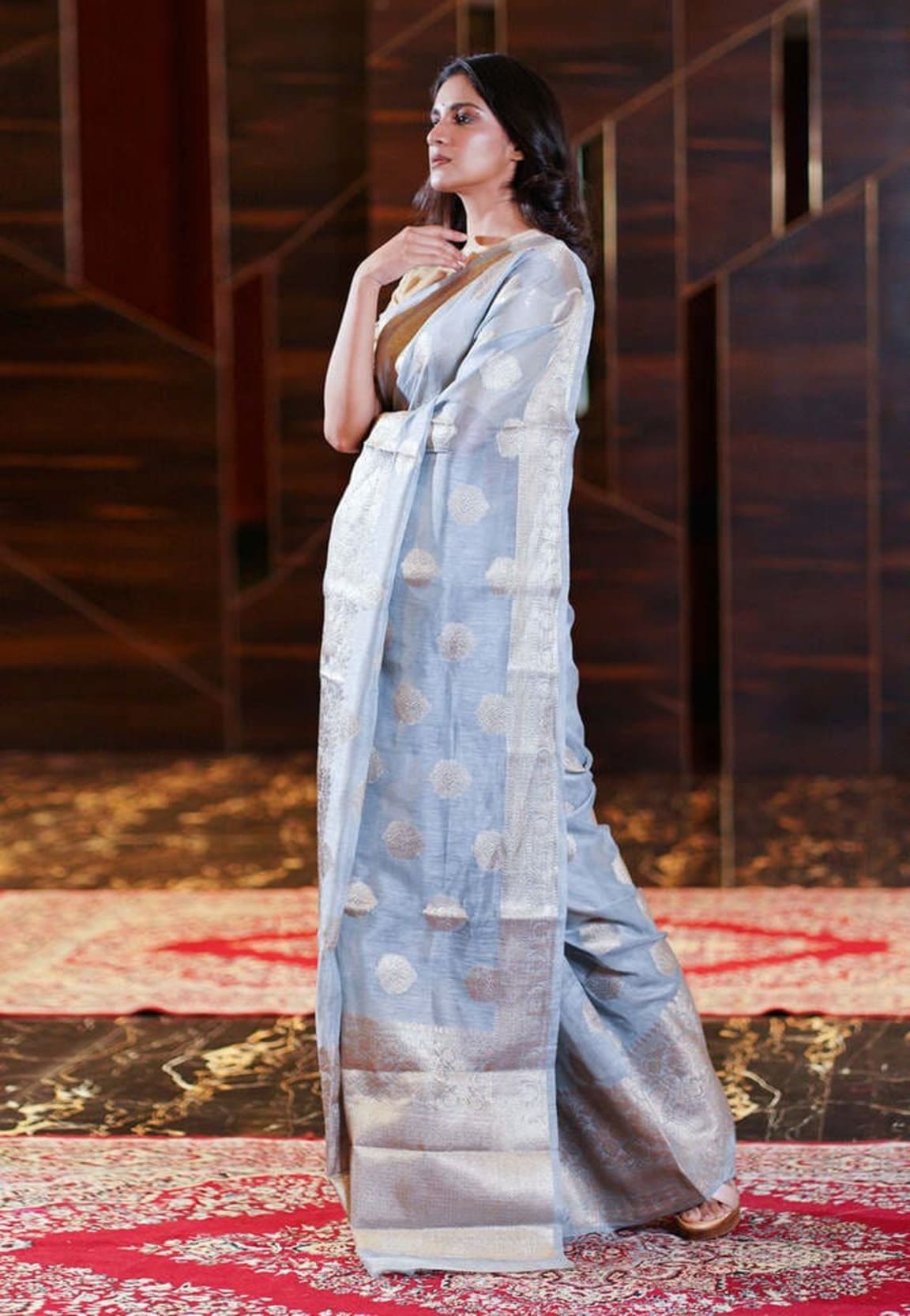 Ash-grey Banarasi linen saree side drape with circular motifs and defined border