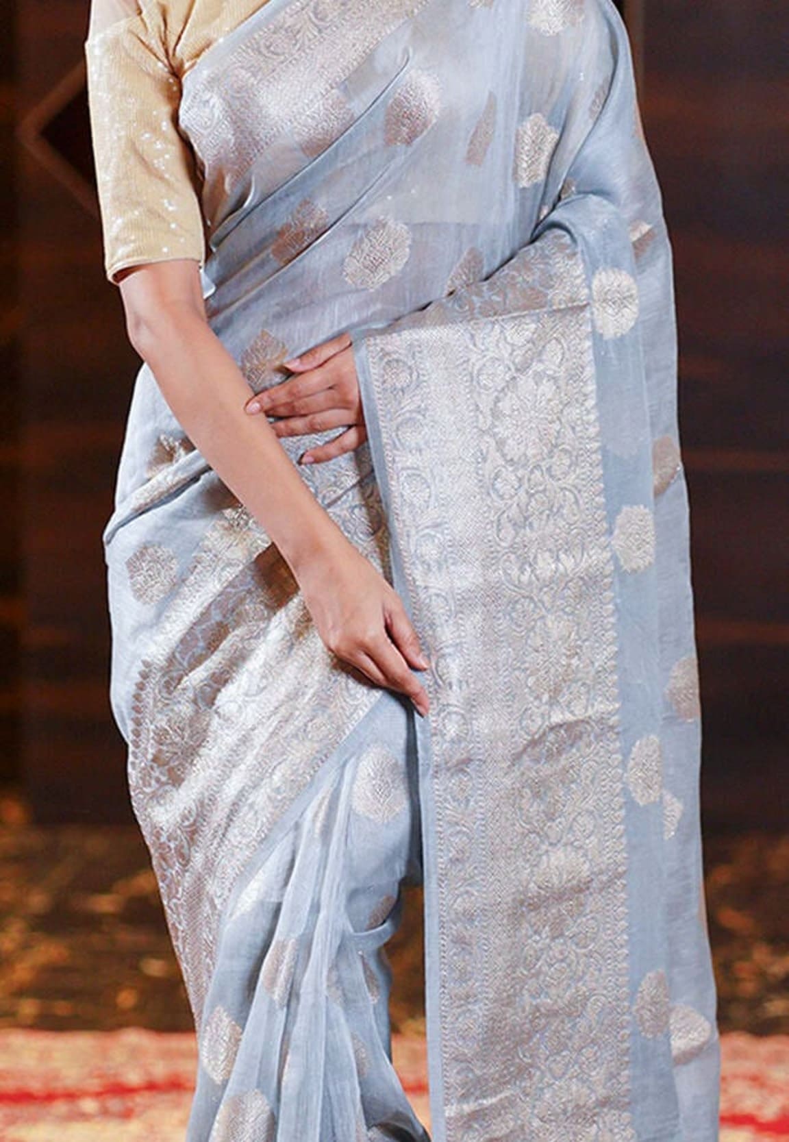 Ash-grey linen saree close-up of woven panel, motifs, and border edge