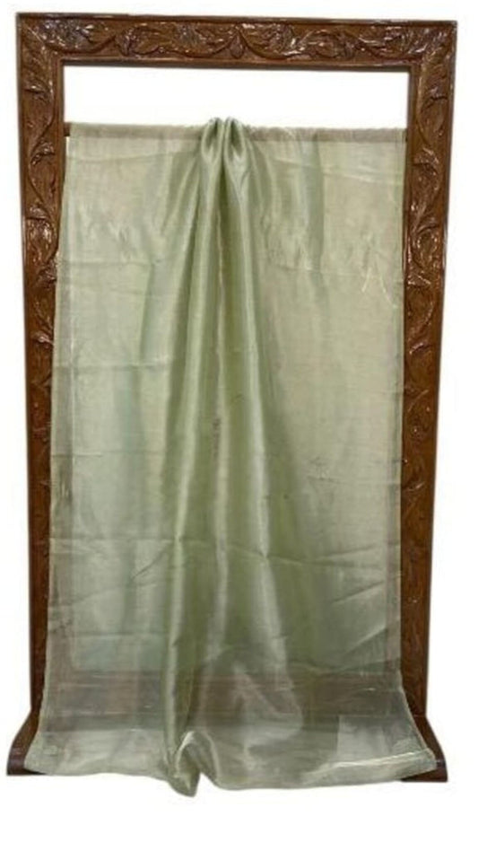 Light green saree laid out on display frame, sheer drape with pleated center fold