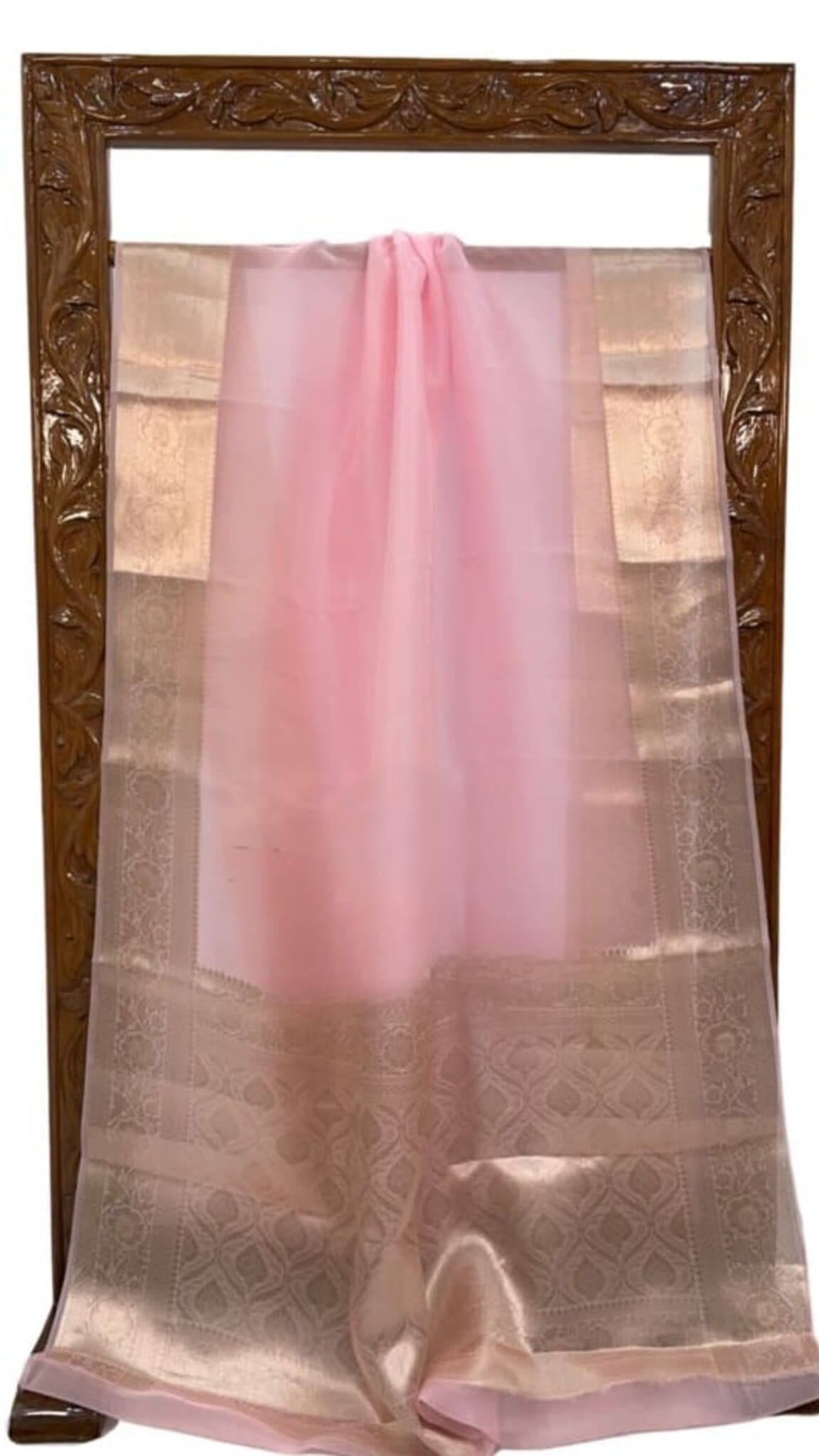 Baby pink saree with gold-toned woven panels and lustrous border, draped