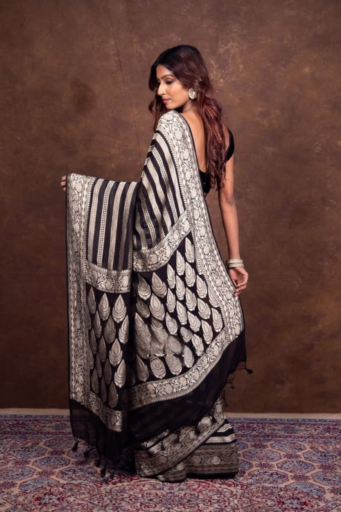 Black and white Banarasi saree draped with silver patterned pallu, side view