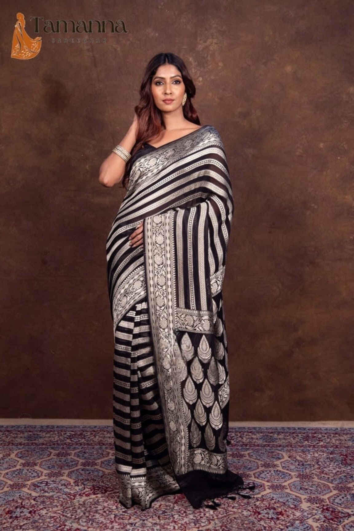 Black and white striped Banarasi saree with ornate silver border, full-length view