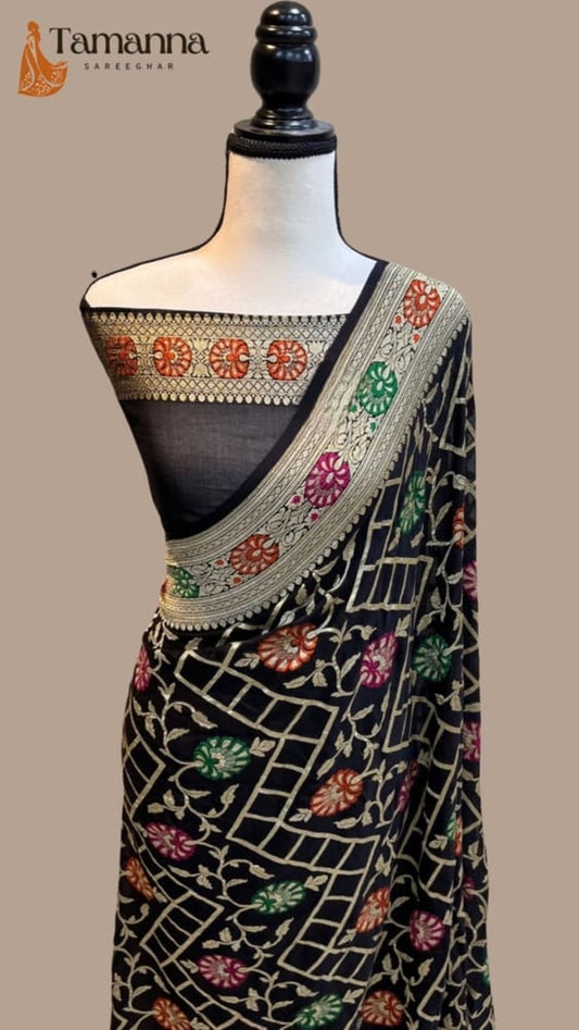 Handloom saree on mannequin with dark base, embroidered border, and patterned pallu