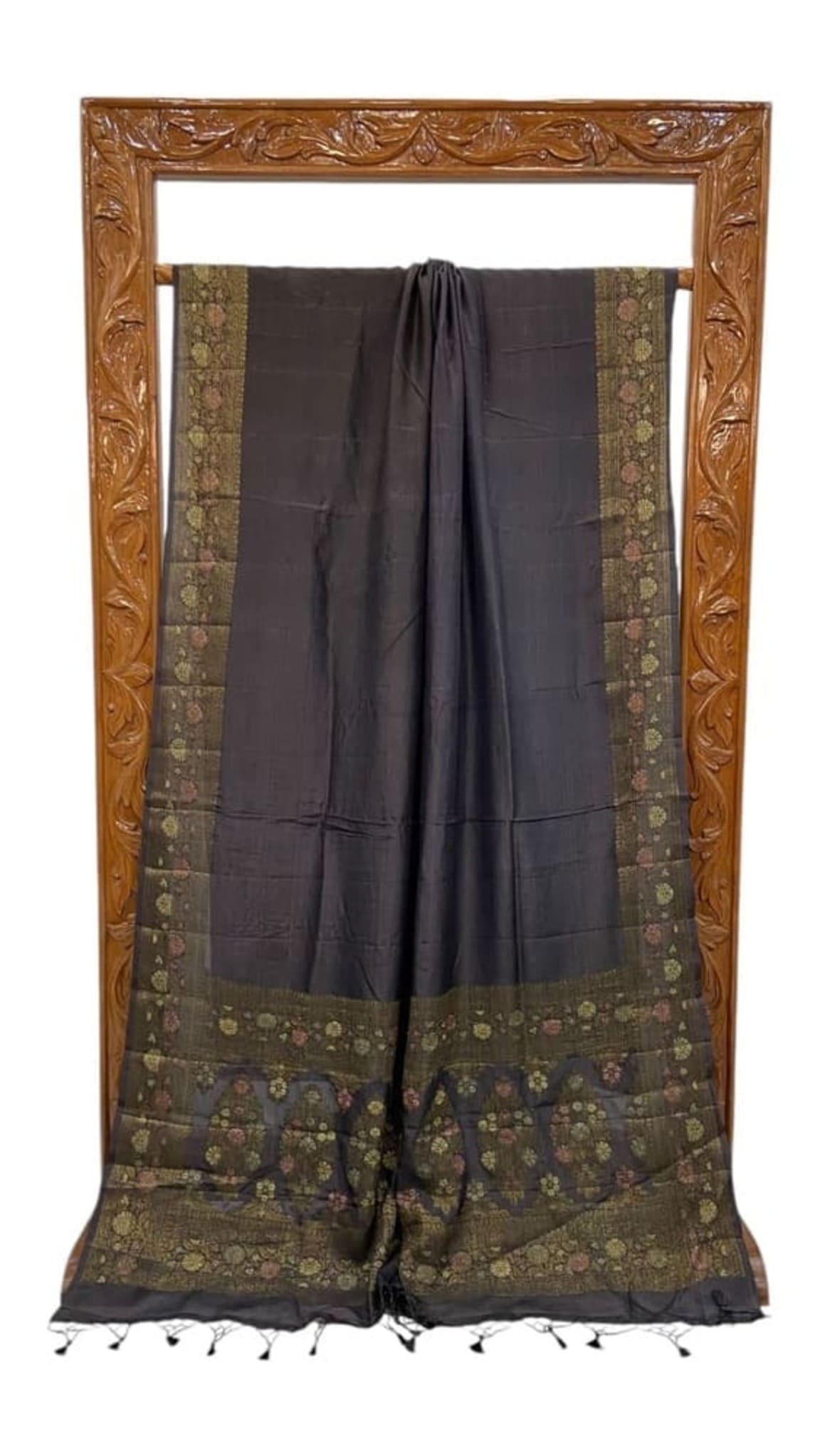 Black crepe saree with dark base and floral zari border, ends with tassels