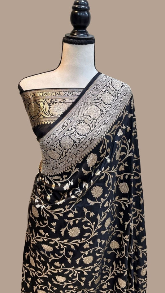 Draped Banarasi silk saree with dark base, gold all-over jaal and detailed pallu border