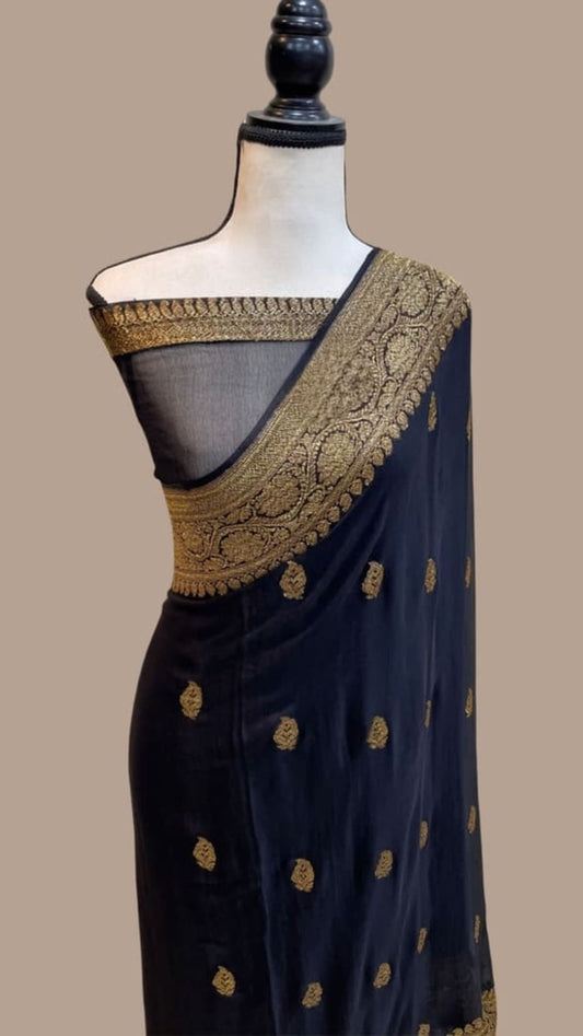 Dark handloom georgette saree with gold-tone border and small motif accents