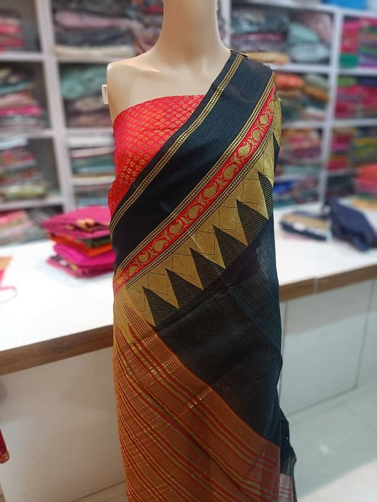 Black pure silk saree drape with gold edging, red blouse panel and patterned trim