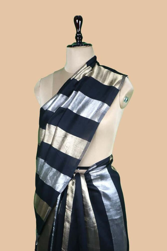 Black and silver striped saree with gold zari border, draped on mannequin