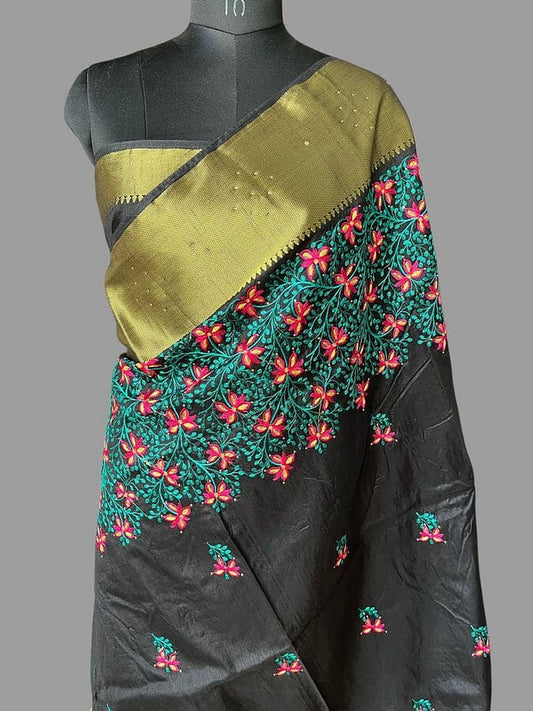 Drape of black silk saree with floral thread embroidery and golden zari border
