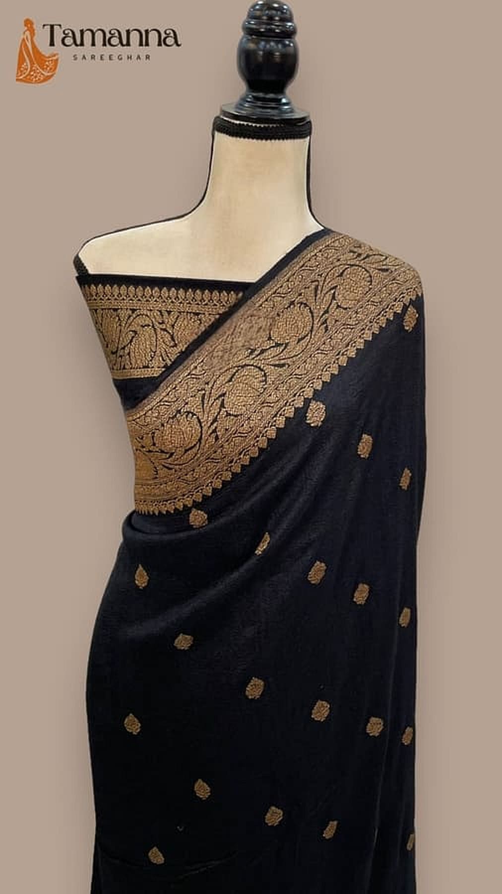 Black tussar georgette saree draped on mannequin, gold kadua motif details