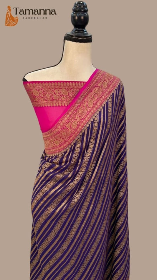 Navy blue saree with magenta pallu border and gold-toned woven zari detailing