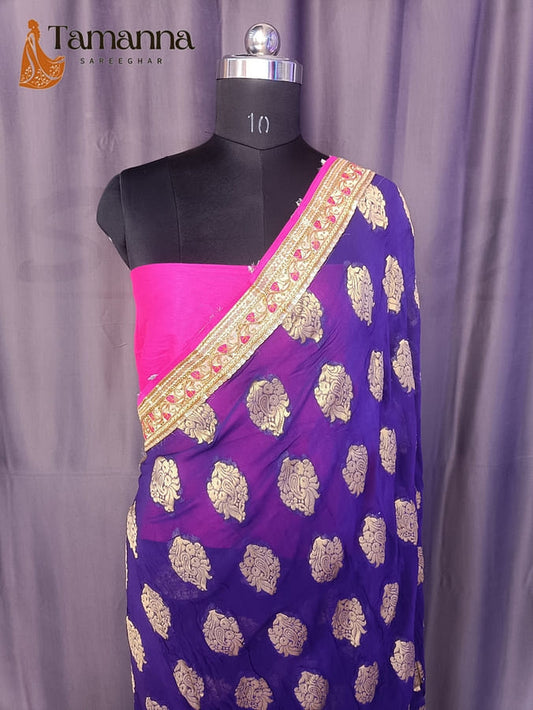 Georgette saree on mannequin, blue with gold motifs and pink pallu panel, wide gold border
