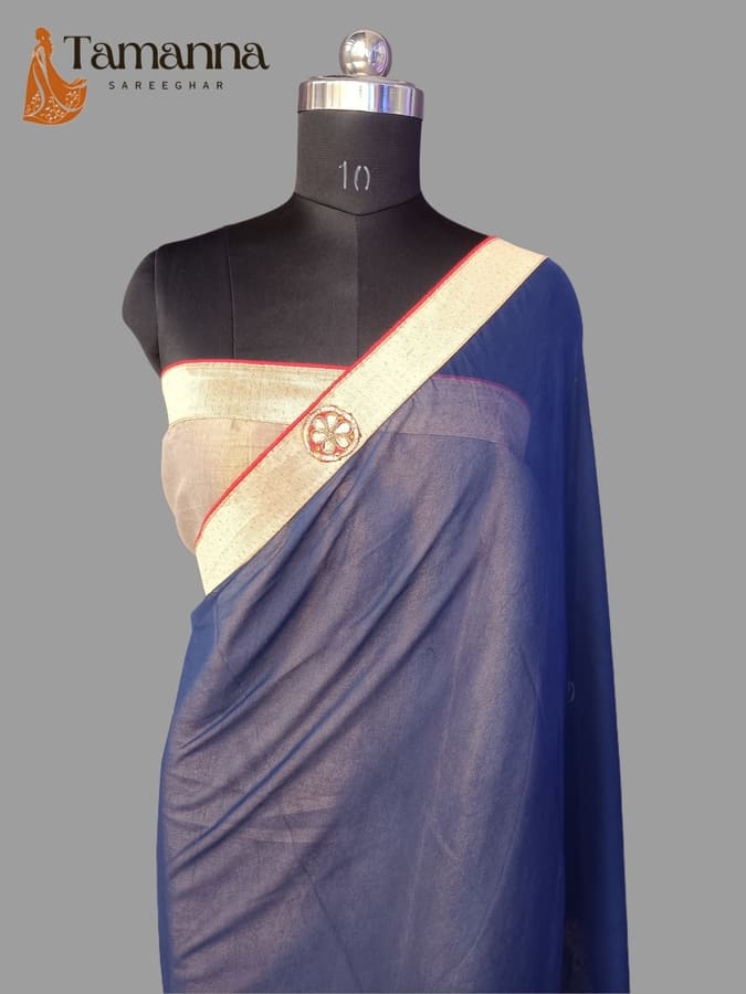 Blue chiffon saree with gold border, draped sash and round motif