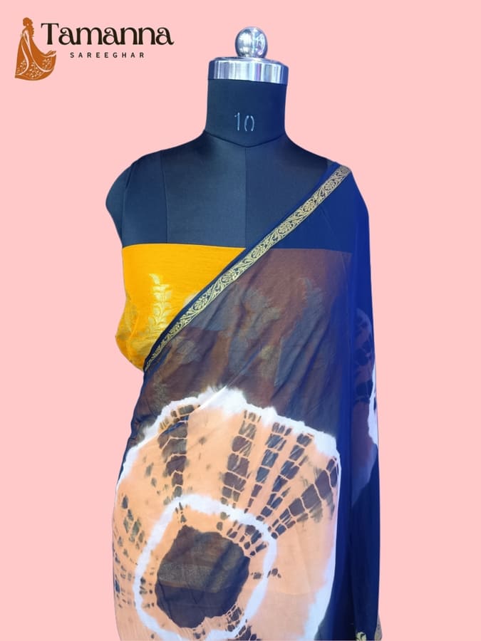Blue chiffon saree with yellow band, circular tie-dye print on dark blue drape
