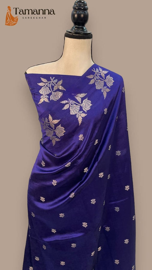Blue silk saree with gold floral vines and pleated drape on mannequin