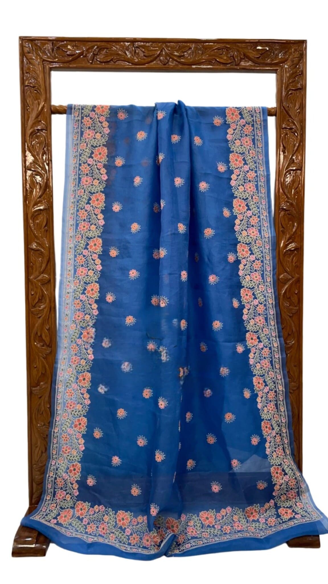 Blue saree draped on display stand, floral motif weave with wide contrast border