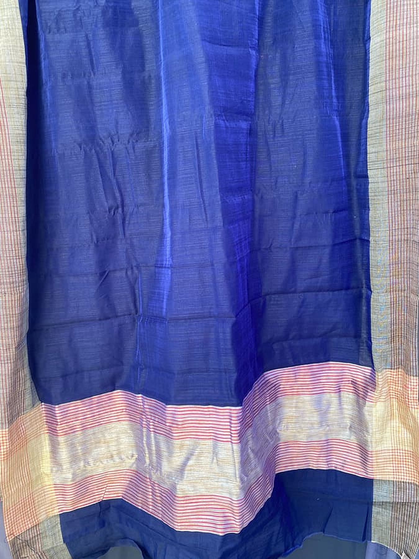Blue silk saree fabric with beige and multicolor striped border at the end