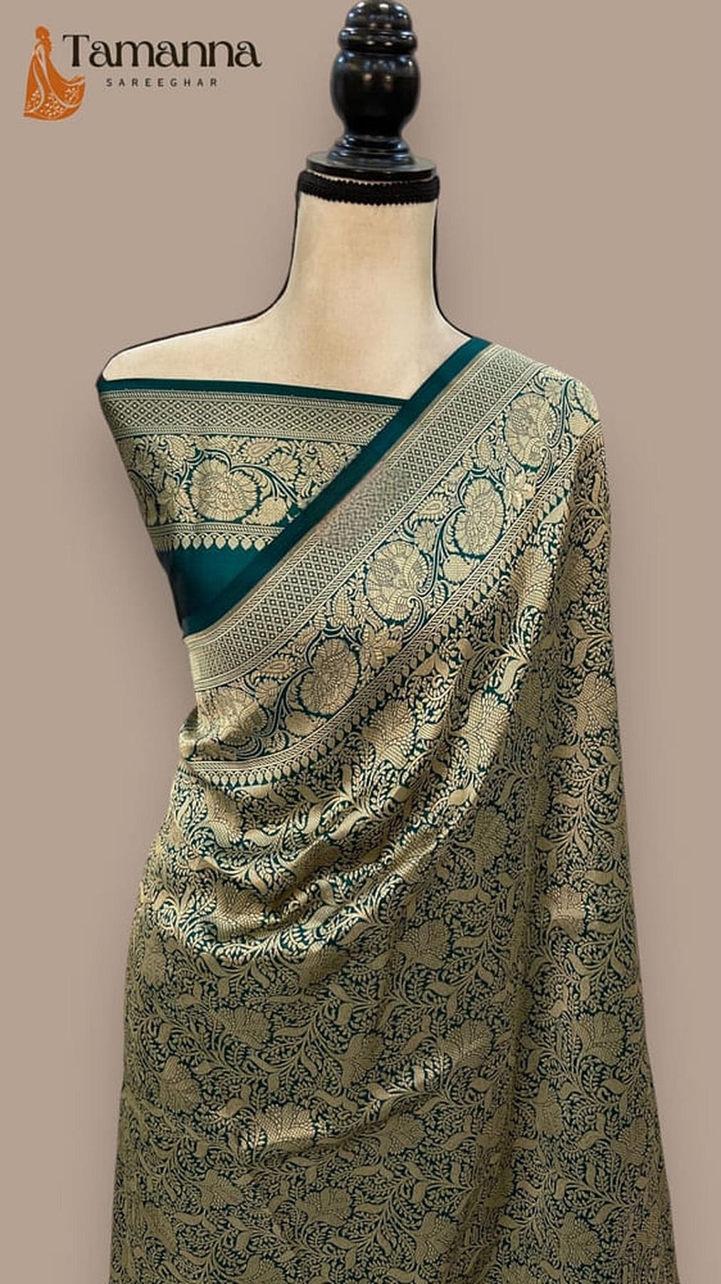Bottle green Banarasi saree with teal pallu border and woven decorative motifs