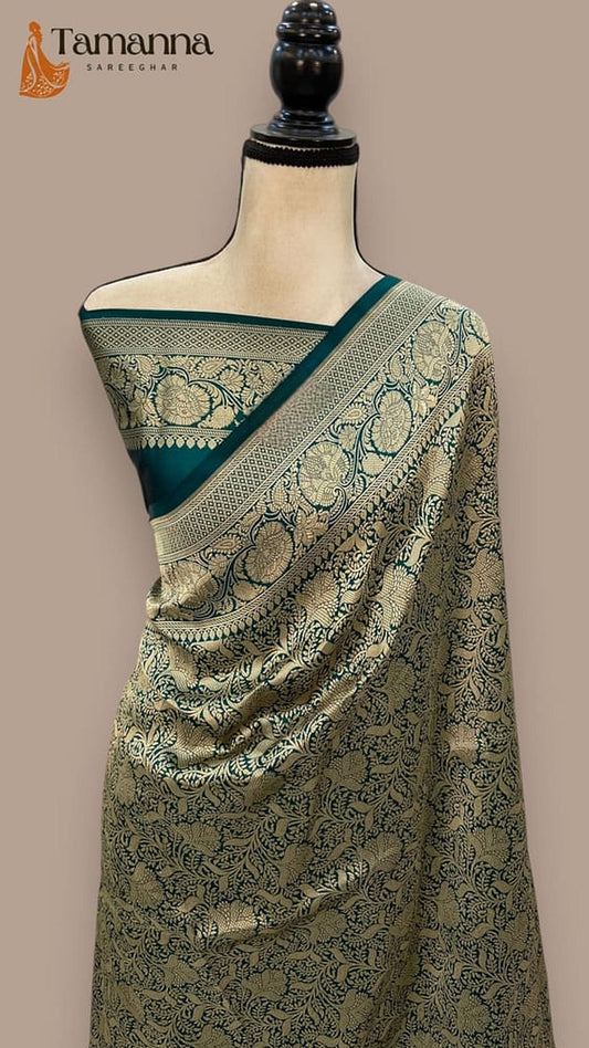 Bottle green Banarasi saree with teal pallu border and woven decorative motifs
