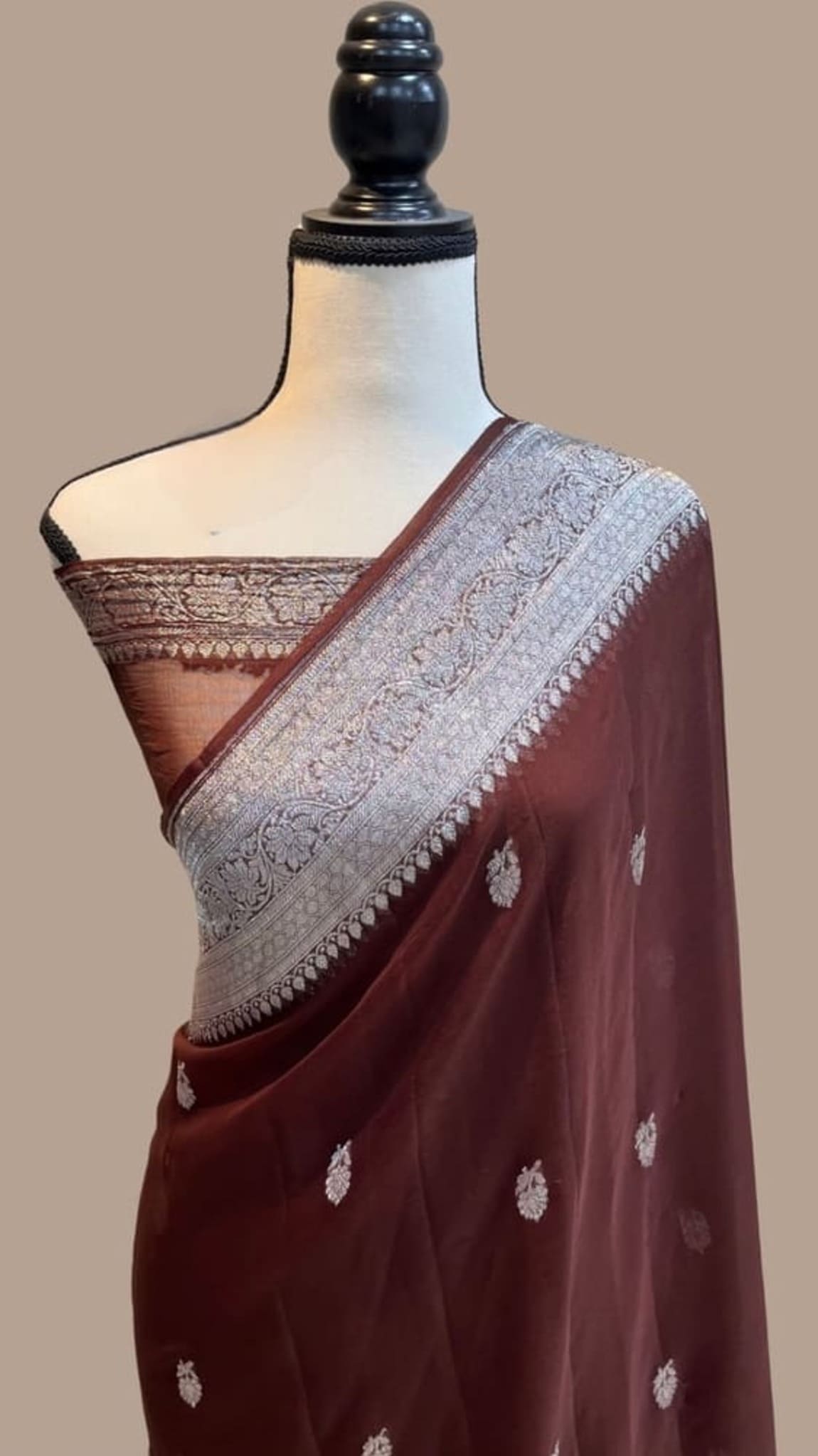 Dark maroon saree drape with wide light silver border and tiny metallic paisley accents