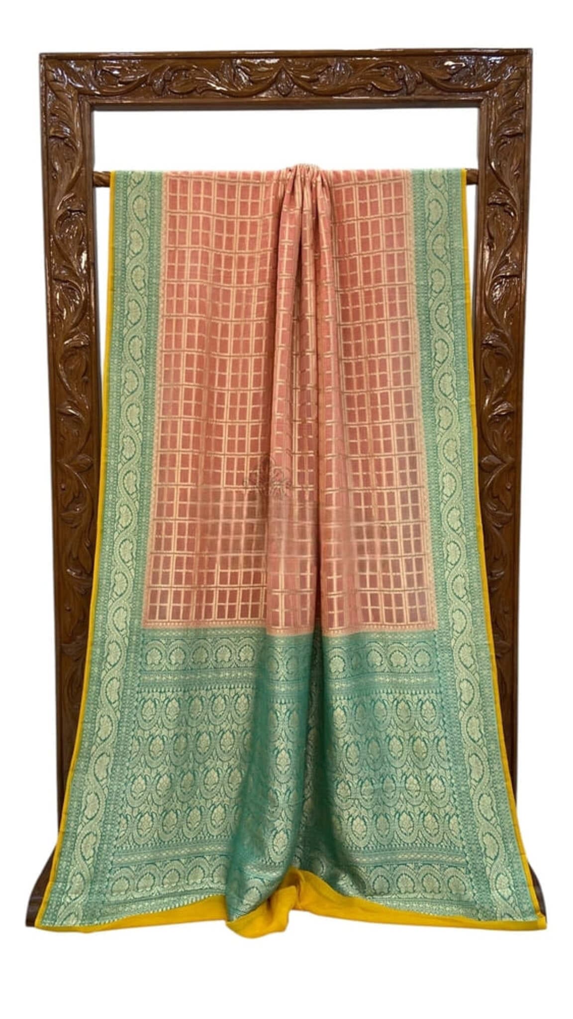 Banarasi saree shown folded: peach check weave, teal border with gold trim