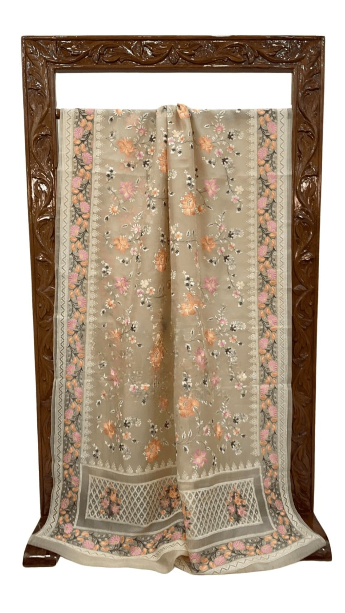 Floral beige organza saree, folded with patterned border and pallu detailing