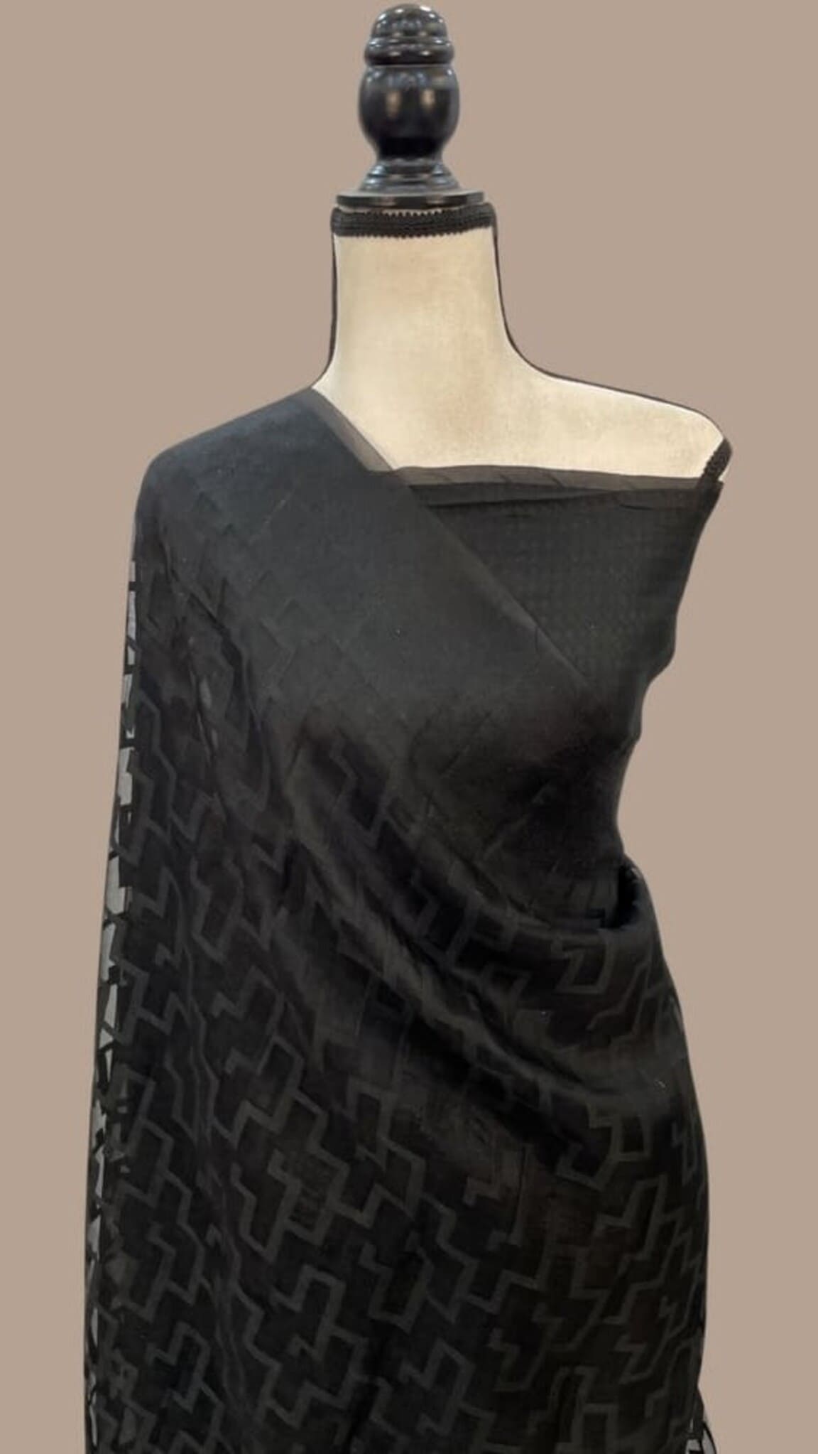 Black Banarasi-style saree with diagonal geometric weave, draped on mannequin
