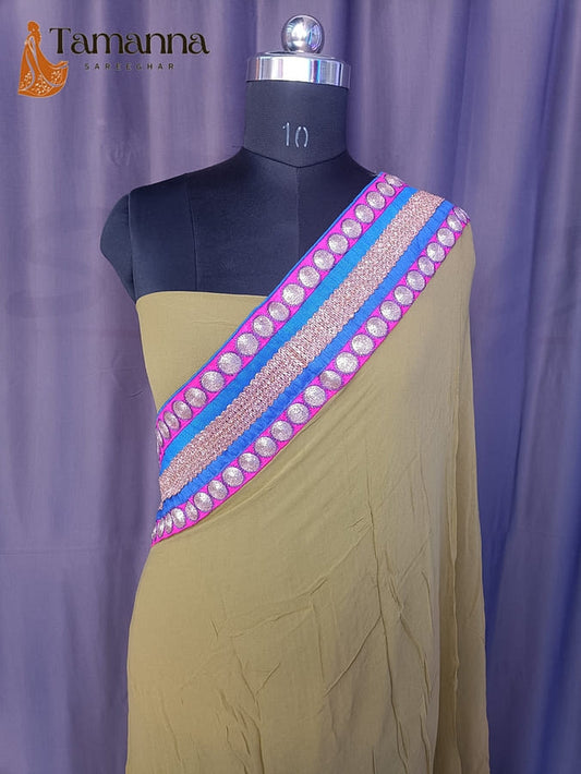 Light beige saree with diagonal purple-pink border strip and jeweled round motifs