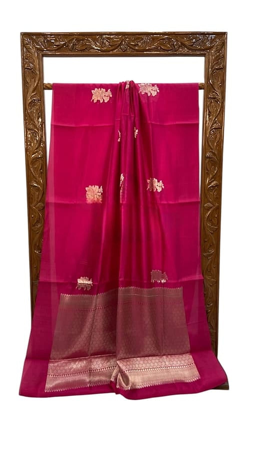 Cherry red Banarasi silk saree, full length on stand, wide gold border and sheen