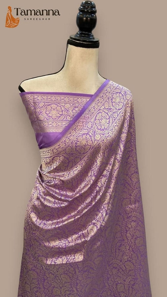 Violet Banarasi silk saree draped on mannequin, gold-tone zari border and motif work
