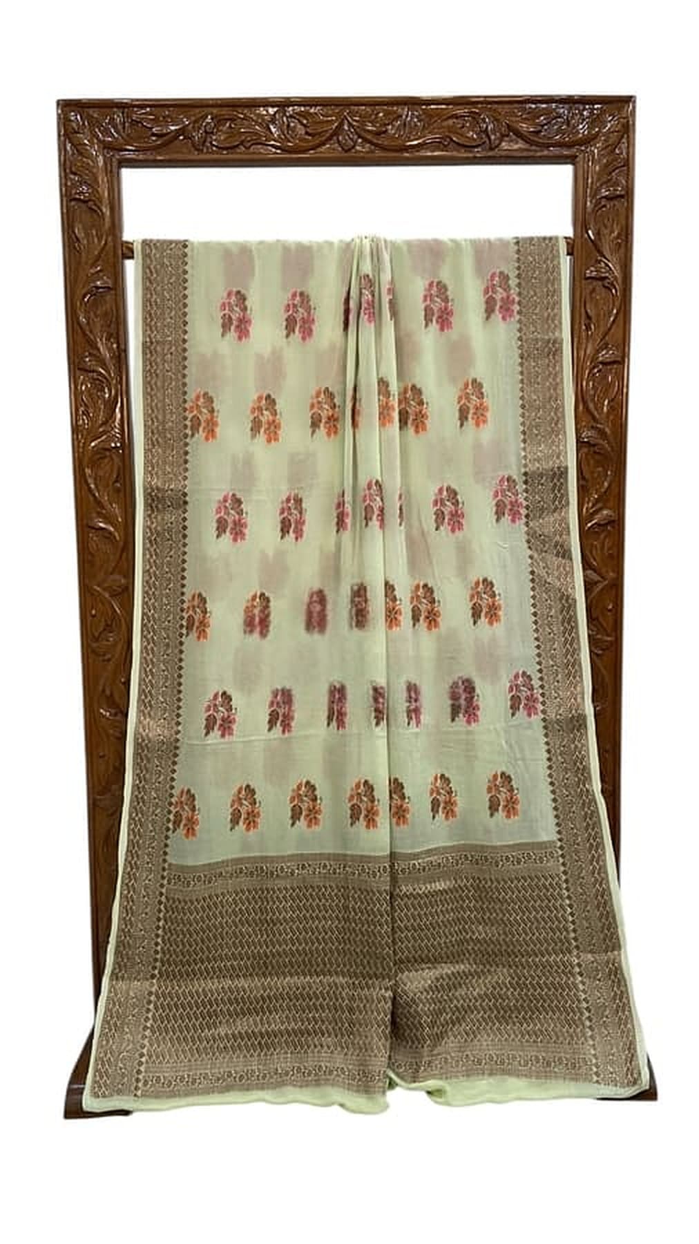Mint green saree laid flat with red floral motif repeats and gold woven section