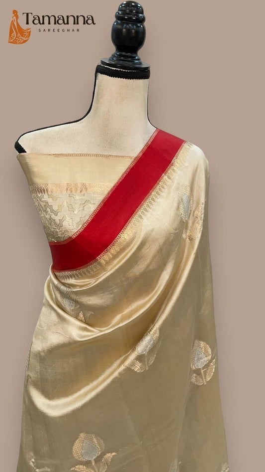 Cream mango silk Banarasi saree with red pallu and gold zari work, on mannequin