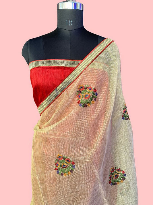 Cream pure silk saree draped with red-gold border and colorful floral motifs