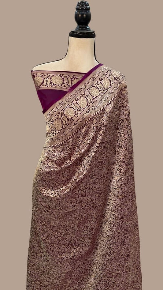 Deep purple silk Banarasi saree draped on mannequin, gold zari pallu and motifs